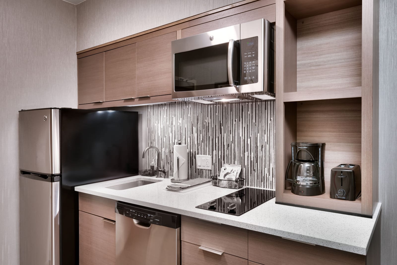 In-suite kitchen with stovetop and full-size refrigerator at TownePlace Suites by Marriott Los Angeles LAX/Hawthorne